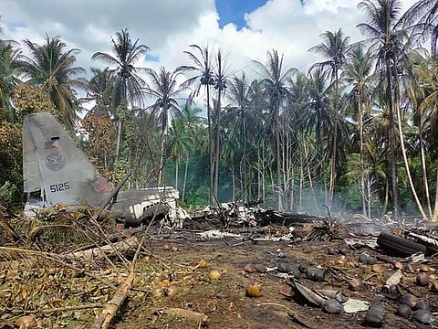 Smoke billows from the wreckage of a Philippine Airforce C-130 transport plane after it crashed near the airport in Jolo town, near Sulu province.
