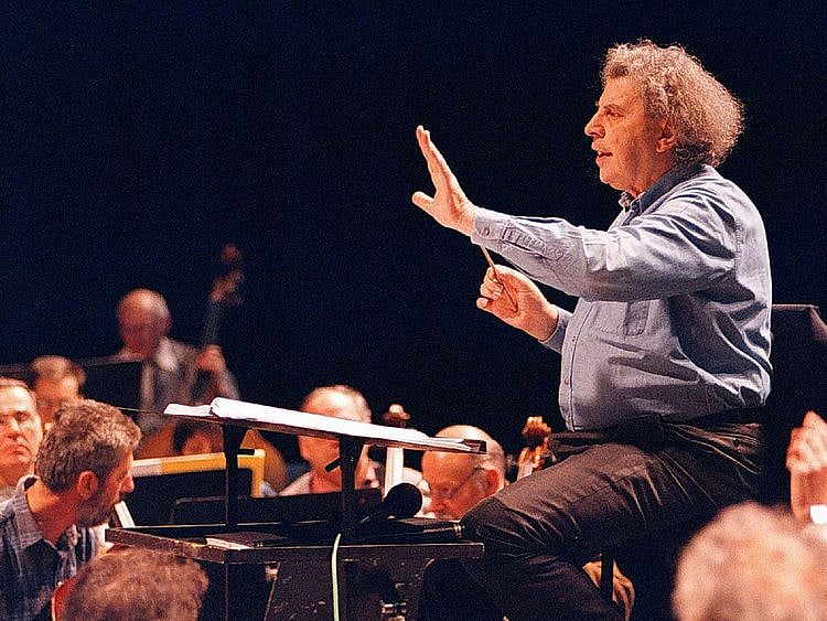 FILE PHOTO: Greek composer Mikis Theodorakis conducts the Skopje's opera orchestra during a rehearsal in the Macedonian capital, April 9, 1997. Stringer/File Photo