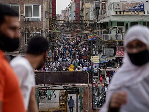People are seen in a crowded marketplace amidst the spread of COVID-19, in the old quarters of Delhi, India