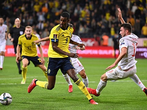 Sweden's forward Alexander Isak (left) and Spain's defender Aymeric Laporte vie for the ball during the FIFA World Cup Qatar 2022 qualification Group B football match at the Friends Arena in Solna, Sweden.