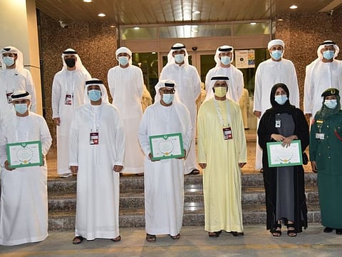 Dubai Police officials with the volunteers. 