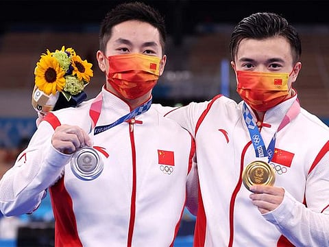 Liu Yang (R) and You Hao of China celebrate after the men's rings final at the Tokyo Olympics in Tokyo, Japan, August 2, 2021