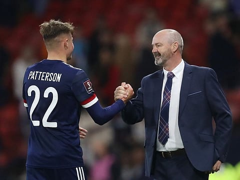 Scotland manager Steve Clarke celebrates with Nathan Patterson after the match.