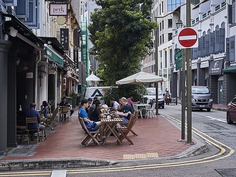 Customers at a cafe in the central business district in Singapore, on Monday, September 6, 2021.  