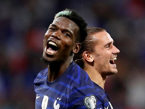 France's Antoine Griezmann celebrates scoring their second goal with Paul Pogba.