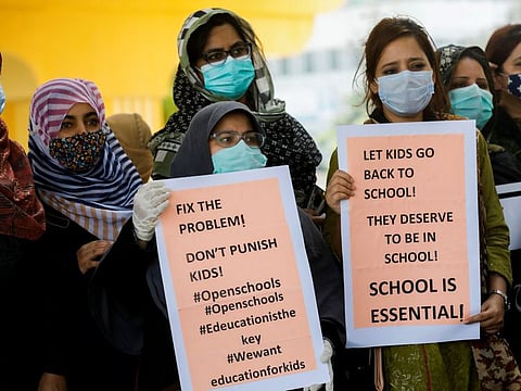 Teachers of private schools hold signs during a protest demanding the opening of schools in Karachi in a file picture. According to an estimate, 52 per cent of the children belonging to the poorest communities in Sindh, of whom 58 per cent are girls, are out-of-school.