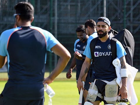 India's Ravichandran Ashwin (left) and India's captain Virat Kohli. India cancelled Thursday's optional training session after another positive COVID-19 test result among their coaching staff.