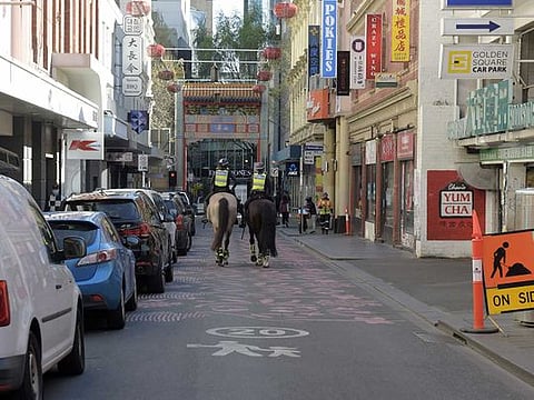 Mounted police ride through Chinatown in Melbourne, Australia, on September 8, 2021. 