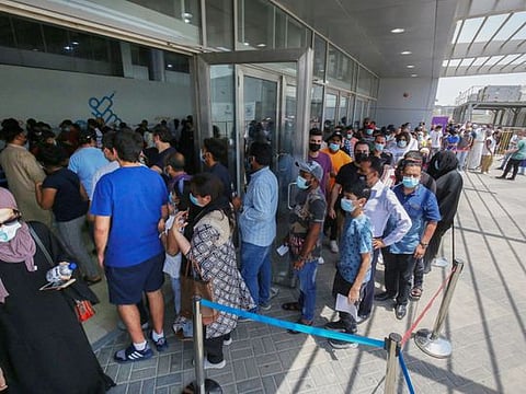 People queue to receive a dose of the COVID-19 vaccine at an inoculation centre in Kuwait City. The improving health situation coincides with 70 per cent of citizens and residents receiving both doses of the COVID-19 vaccine.