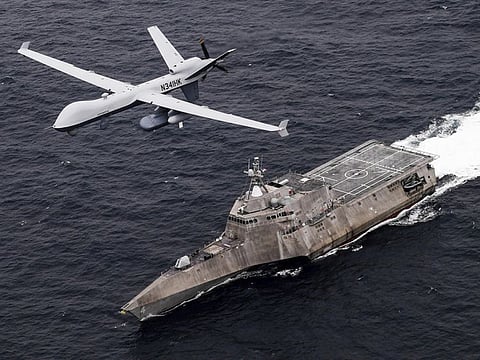 An MQ-9 Sea Guardian unmanned maritime surveillance drone flies over the USS Coronado in the Pacific Ocean during a drill April 21, 2021.  