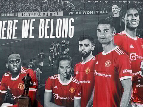A picture of Cristiano Ronaldo with teammates is displayed on the outside of Old Trafford.