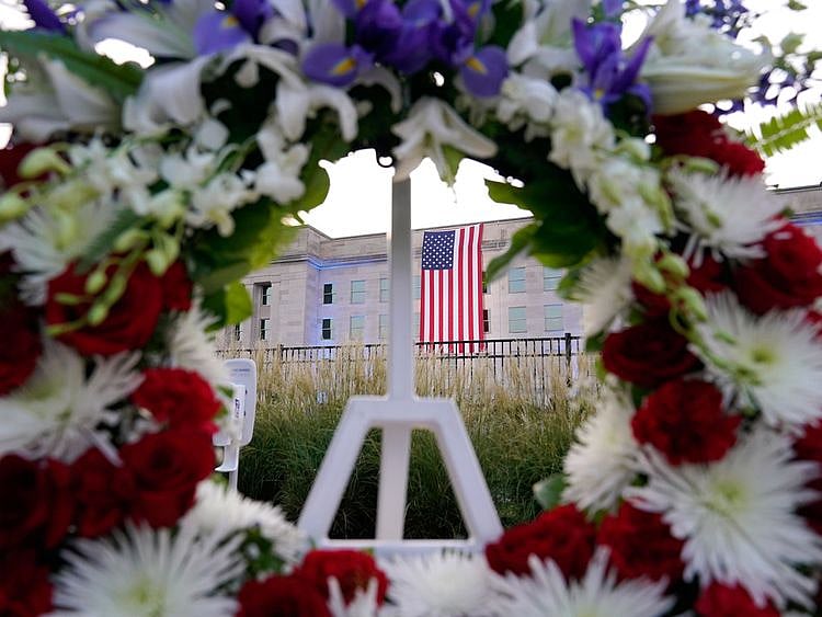 An American flag is unfurled at the Pentagon in Washington, Saturday, September 11, 2021, at sunrise on the morning of the 20th anniversary of the terrorist attacks. The American flag is draped over the site of impact at the Pentagon.