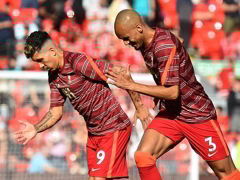 Liverpool's Brazilian players Roberto Firmino and Fabinho.