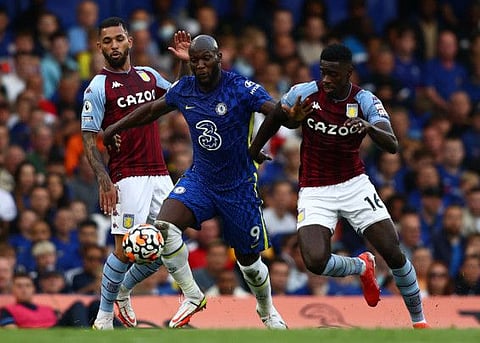 Chelsea's Belgian striker Romelu Lukaku (centre) beats Aston Villa's English defender Axel Tuanzebe (right) during their English Premier League football match at Stamford Bridge in London.
