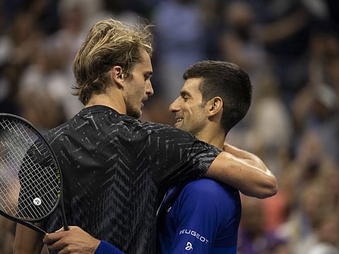 Novak Djokovic of Serbia embraces Alexander Zverev of Germany, left, after winning their U.S. Open semifinal match, 4-6, 6-2, 6-4, 4-6, 6-2, at Arthur Ashe Stadium in New York. Djokovic will face Russia’s Daniil Medvedev in the final with a chance to become the first man to win the grand slam in tennis since 1969.
