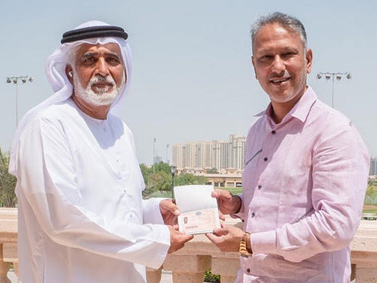 Indian golfer Jeev Milkha Singh receiving his Dubai Golden Visa from Ismail Sharif, Managing Director of Jumeirah Golf Estates. 