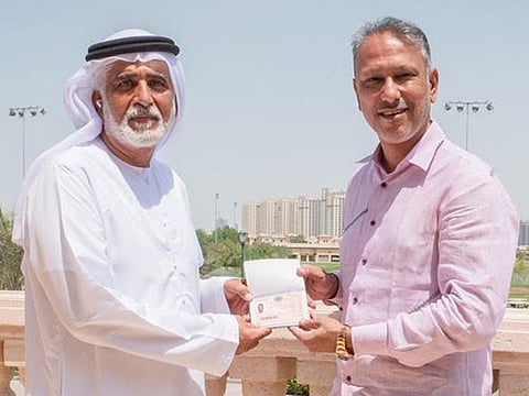 Indian golfer Jeev Milkha Singh receiving his Dubai Golden Visa from Ismail Sharif, Managing Director of Jumeirah Golf Estates. 