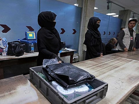 Afghan women airport workers are pictured at a security checkpoint of the airport in Kabul on September 12, 2021.  Of the more than 80 women working at the airport before Kabul fell to the Taliban on August 15, just 12 have returned to their jobs. 
