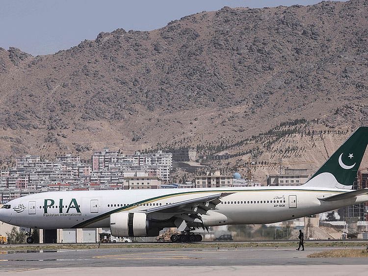  A Pakistan International Airlines plane carrying a handful of passengers, which is the first international commercial flight to land since the Taliban retook power in Afghanistan on August 15, lands at the airport in Kabul, on September 13, 2021. 