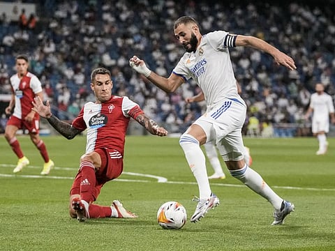 Keen tussle... Real Madrid's Karim Benzema (right) vies for the ball during the Spanish La Liga match against Celta de Vigo at the Bernabeu stadium in Madrid, Spain.