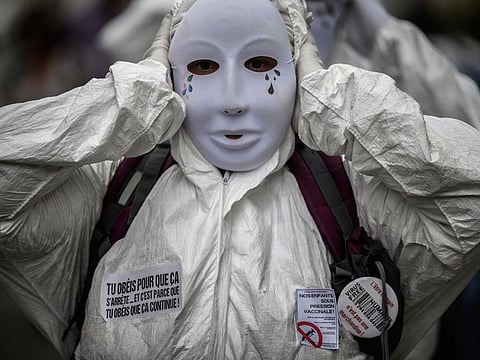 A demonstrator protests against mandatory health passport 'pass sanitaire' obligation for hospital workers in front of The A.R.S (regional  ealth agency) in Lyon, south-eastern France on September 14, 2021.