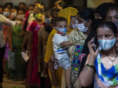 Women wait to receive the vaccine for COVID-19 during a special drive in Mumbai, on September 7, 2021. 