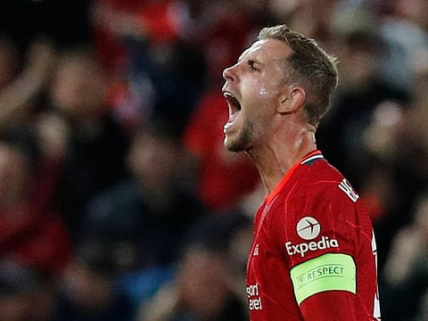 Liverpool's Jordan Henderson celebrates scoring their third goal.