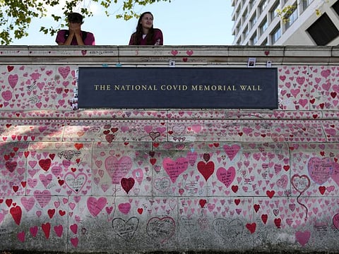 Nurses from the nearby hospital rest atop the National COVID-19 Memory Wall in London, on September 16, 2021. 