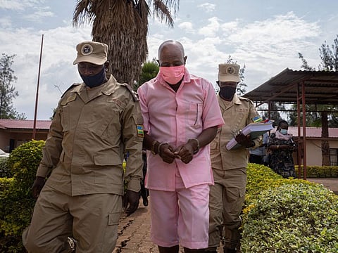 In this file photo taken on October 2, 2020 "Hotel Rwanda" hero Paul Rusesabagina arrives at Nyarugenge Court of Justice in Kigali, Rwanda, surrounded by guards of Rwanda Correctional Service (RCS). 