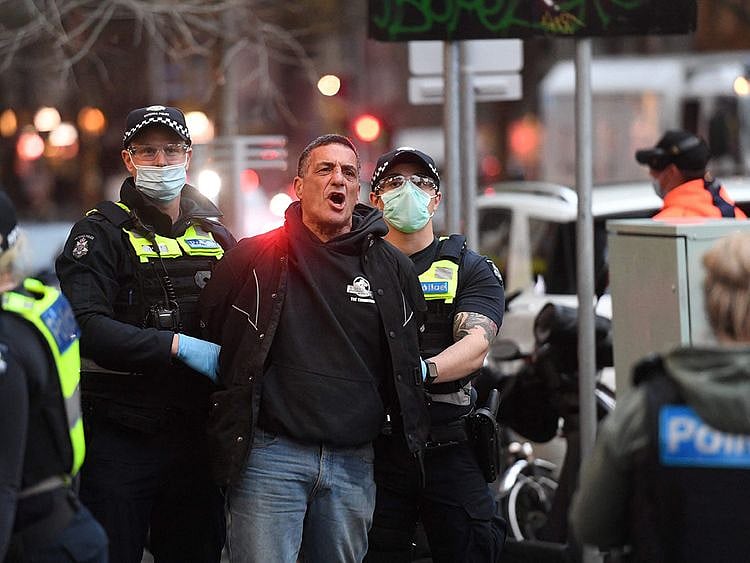 Police arrest a demonstrator in Melbourne on September 21, 2021.