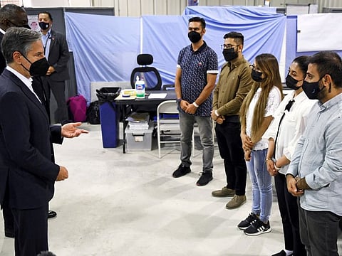 US Secretary of State Antony Blinken and US Secretary of Defence Lloyd Austin meet with Afghan interpreters at Al Udeid Air Base which houses Afghan refugees, in Doha, on September 7, 2021.  UK Prime Minister Boris Johnson earlier this month said 311 people were left behind who were eligible under the UK’s Afghan Relocations and Assistance Policy, such as interpreters.