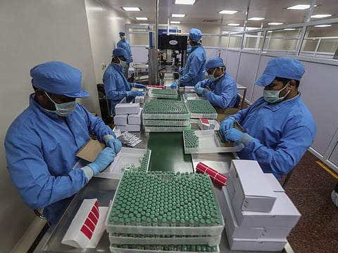 Employees pack boxes containing vials of Covishield, a version of the AstraZeneca vaccine at the Serum Institute of India in Pune. India, the world's largest vaccine producer, says it will resume exports and donations of surplus coronavirus vaccines in October after halting them during a devastating surge in domestic infections in April. 