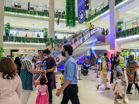 Shoppers walk through an atrium at the Dolmen Mall Clifton in Karachi, on September 20, 2021.  Pakistan’s COVID-19 cases are declining slowly but steadily. 