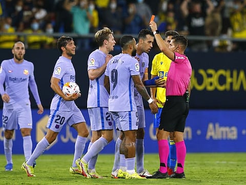 Barcelona's Frankie de Jong is shown a red card by referee Carlos del Cerro Grande at the Estadio Nuevo Mirandilla, Cadiz, Spain.