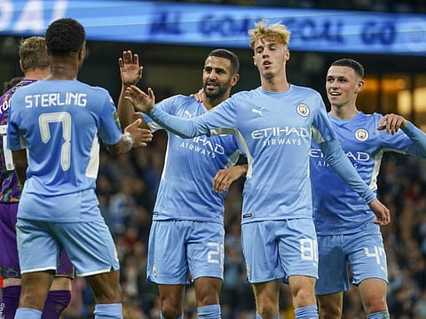 Manchester City's Riyad Mahrez (centre) celebrates with teammates after scoring his team's fifth goal during the English League Cup third round match against Wycombe Wanderers at Etihad Stadium, in Manchester England. City face table-toppers Chelsea tomorrow and cannot afford to lose.