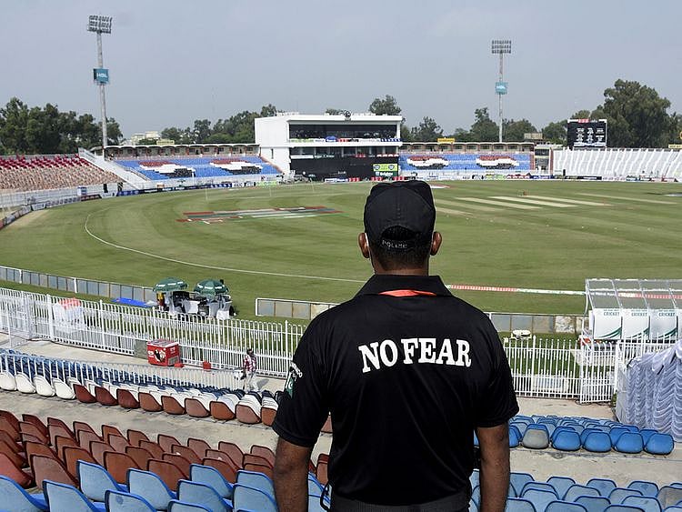 A member of the Police Elite Force stands guard at the Rawalpindi Cricket Stadium in Pakistan