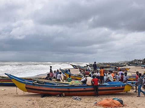 Fishermen anchor their boats on Puri beach as IMD restricts venturing in the sea due to Cyclone Gulab, Sunday, Sept. 26, 2021. 
