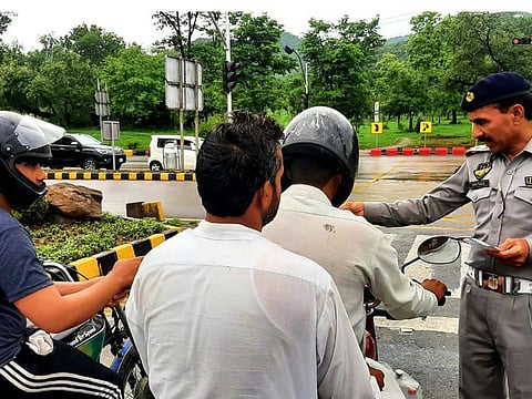 Police checking documents of motorists in a file photo in Islamabad.