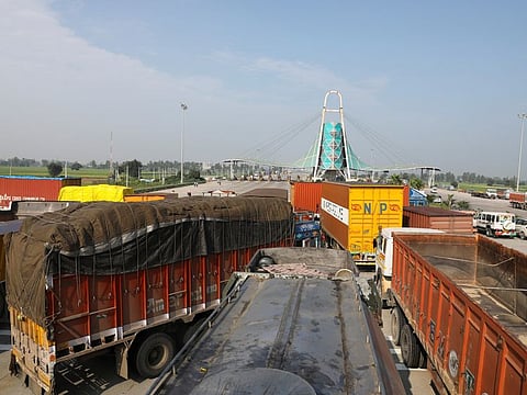 Goods trucks and other vehicles parked at a toll plaza on the KMP expressway as farmers block national highways, as part of protests against farm laws during nationwide protests, near Kundli border, in Haryana, on September 27, 2021.