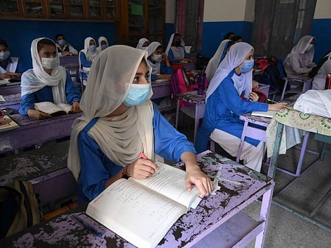 Students attend a class at a school in Lahore on September 16, 2021, after the government reopened educational institutes.