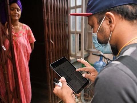 An enumerator introduces houses and household data in a tablet for the 2021 population census conducted by the Central Bureau of Statistics, in Kathmandu on September 29, 2021. 