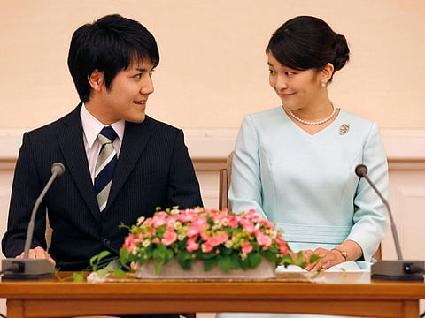 This file picture taken on September 3, 2017 shows Japan's Princess Mako, the eldest daughter of Prince Akishino and Princess Kiko, and her fiancee Kei Komuro at a press conference to announce their engagement at the Akasaka East Residence in Tokyo. - The Imperial Household Agency said on October 1, 2021 that Princess Mako, who is the niece of Emperor Naruhito, will marry Kei Komuro on October 26, local media reported.