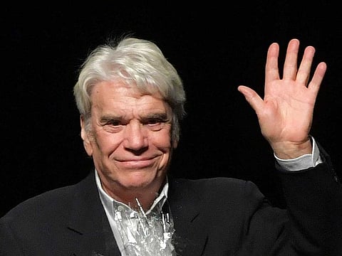 In this file photograph taken on September 27, 2018, French businessman and former politician Bernard Tapie waves after addressing a conference at the Chamber of Commerce in Liege.  Bernard Tapie died at the age of 78, his family announced on October 3, 2021.