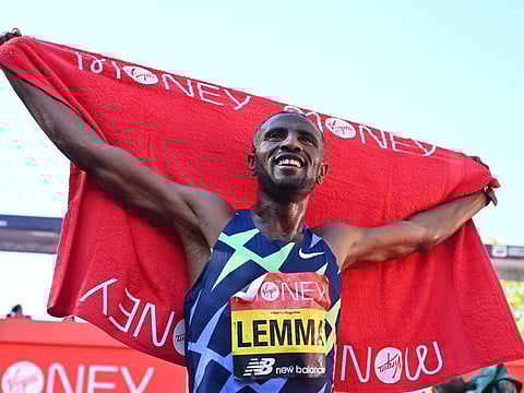 Ethiopia's Sisay Lemma celebrates after he wins the elite men's race of the 2021 London Marathon in central London.