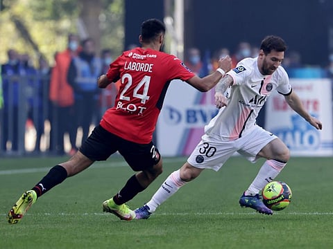 PSG's Lionel Messi (right) is challenged by Rennes' Gaetan Laborde during the French League One match at the Roazhon Park stadium in Rennes, France. PSG lost 2-0.