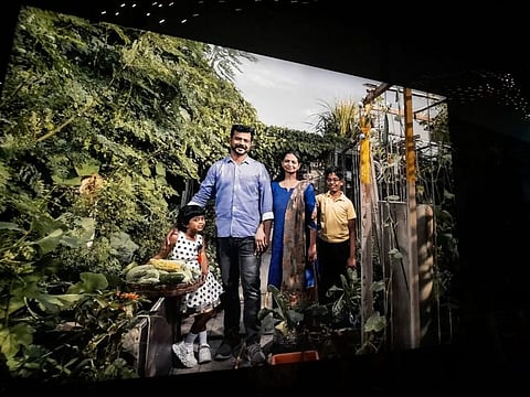 The UAE Pavilion display featuring Praveen Kottavathil and his family against the backdrop of their garden 