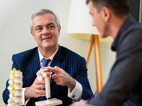Dr Harris Zourelidis, Specialist Orthopaedic Surgeon at Valiant Clinic & Hospital, explains a procedure to a patient