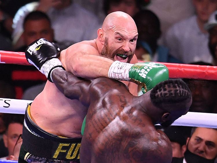 WBC heavyweight champion Tyson Fury of Great Britain lands a punch on US challenger Deontay Wilder 