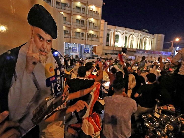 Supporters of Iraqi Shiite cleric Muqtada Al Sadr ride in vehicles while celebrating in the central shrine city of Najaf after the closure of polls during the early parliamentary elections on October 10, 2021