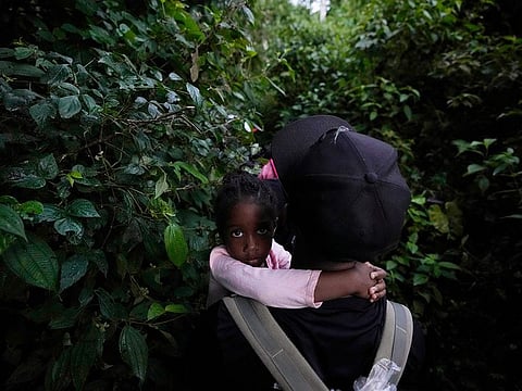 A young migrant being carried north near Acandi, Colombia